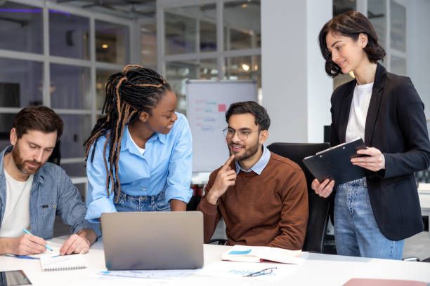 istock Businesspeople smiling while sitting together in a co-working space working on new project 2150716263