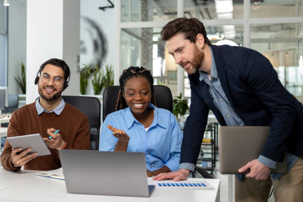 istock Group of diverse businesspeople using laptop while working together 2150716274