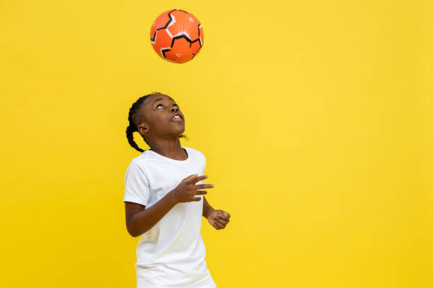 istock Playful little mixed-race boy doing tricks with soccer ball 2150717415