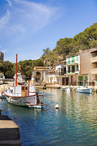 Cala Figuera, Spain -April 20, 2024: Cala Figuera's harbor featuring several fishing boats in its serene bay. It is a popular scenic spot in southeastern Mallorca, visited by numerous tourists every year.