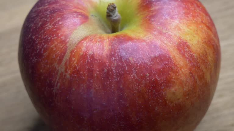 Video with a rotating red apple. One large apple in macro.