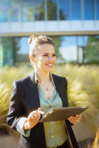 istock happy woman worker near office building using digital tablet 2150722319