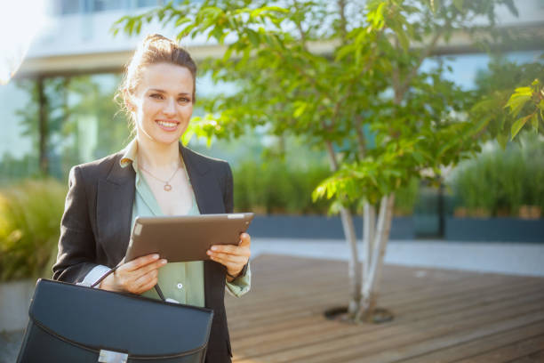 istock smiling female worker near business center using digital tablet 2150722324