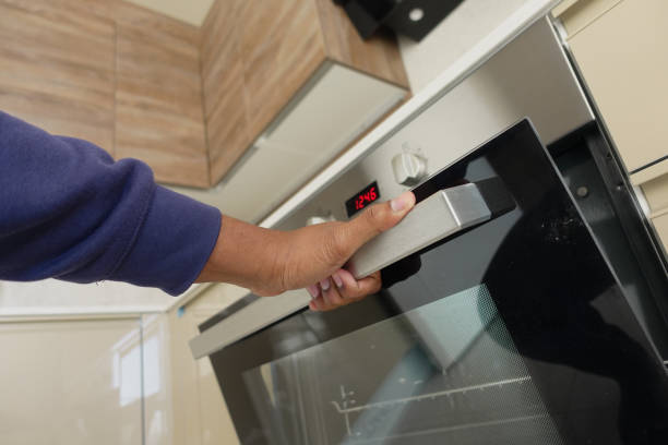 istock person hand open electric oven at home 2150723011