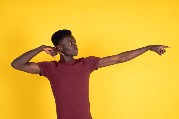 istock A man in a red shirt is pointing to the right 2150723073