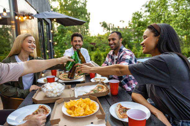 istock Young people enjoying leisure time together outside toasting with beer 2150723332
