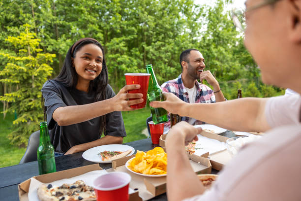 istock Overjoyed friends meeting for picnic together having fun with alcohol 2150723355