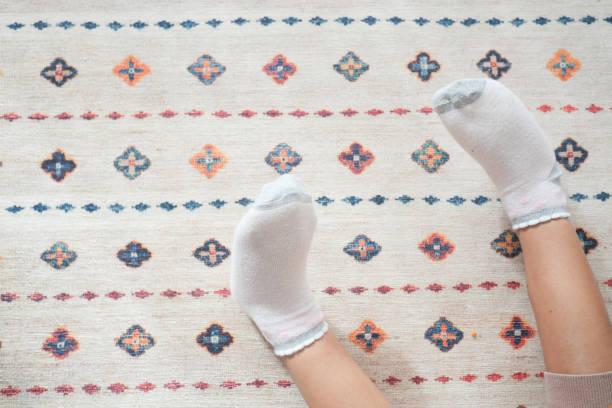 istock top view of child feet on a carpet 2150723405