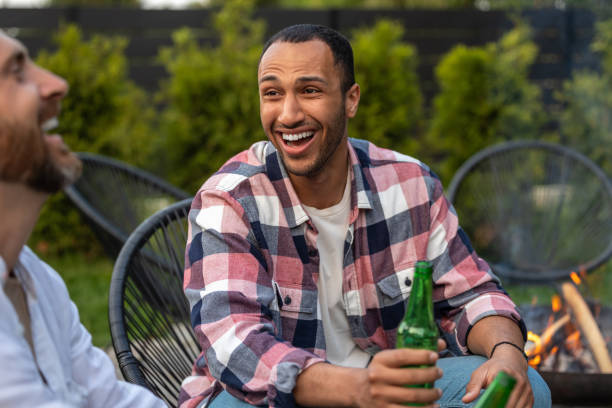 istock Satisfied men friends enjoying drinking beer during summer picnic 2150723460
