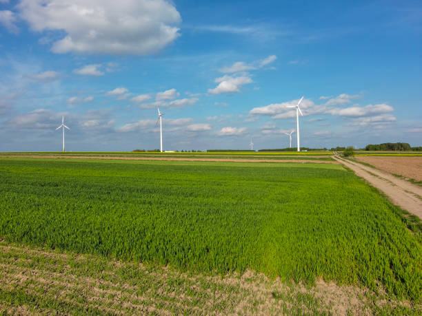 istock Spring farmland and electric windmills. 2150724511