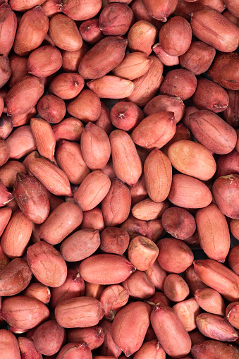 Background of raw unshelled peanuts. Nuts food background, top view.