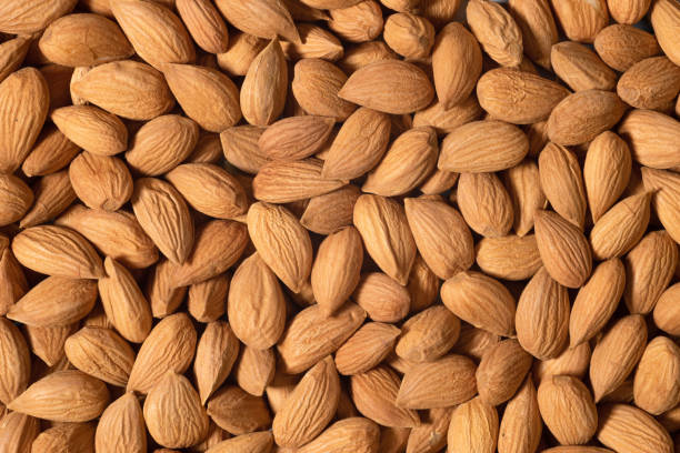 istock Background of raw almonds for background or textures. Unshelled almonds in shell 2150724546