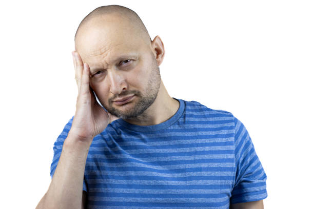 istock A man on a white background with a severe headache holds his hand on his temple 2150725891