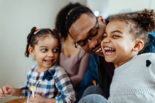 istock Multiracial family with two young daughters enjoying time at home playing 2150727714