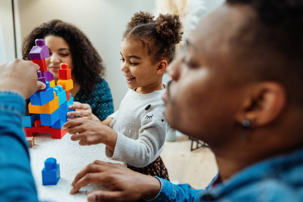 istock Multiracial family with two young daughters enjoying time at home playing 2150727816