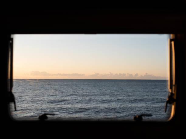 istock Views to the sea and sunrise through a window 2150729423