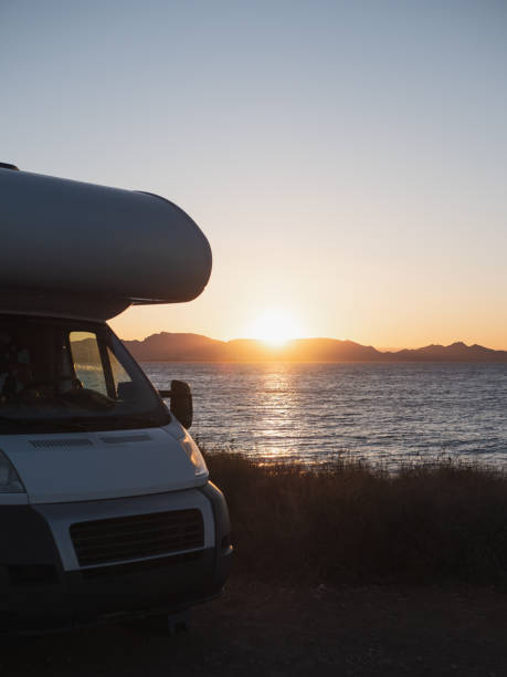 istock Sunset at the motor home by the sea 2150729427
