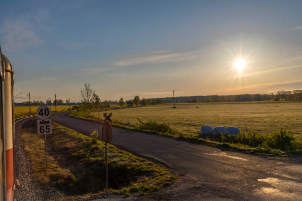 Aerial View of Golden Fields at Sunset, Capturing the Serene Beauty of Rural Landscape with Warm Sunlight and Expansive Farmland