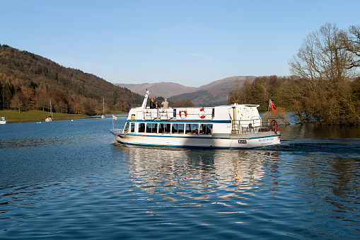 View of a pleasure boat on lake Windermere, UK People can be seen on the boat