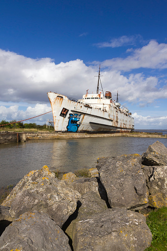 View of an abandoned ship beached at Llannerch-y-Mor Wharf near Mostyn Docks North Wales, UK.  There are no people in the photograph