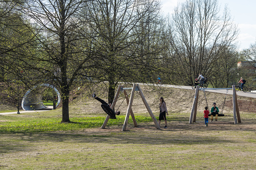 Riga, Latvia - April 28, 2024: People have fun in the park, which was established after the Soviet Victory Monument was demolished