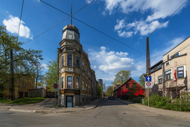 Riga, Latvia - April 28, 2024: A wooden building at the intersection of Eduarda Smilga Street and Slokas Street in the residential area Agenskalns