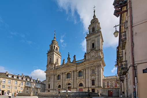 Lugo, Spain - April 29, 2024: An impressive view of a historic cathedral, with towers rising into a clear sky. Cathedral of Lugo