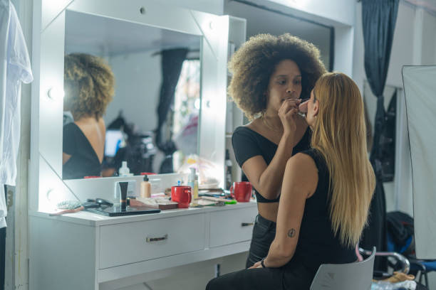 istock Professional makeup artist serves her client inside her beauty salon 2150739282