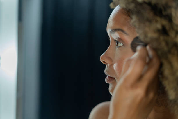 istock Professional makeup artist serves her client inside her beauty salon 2150739329