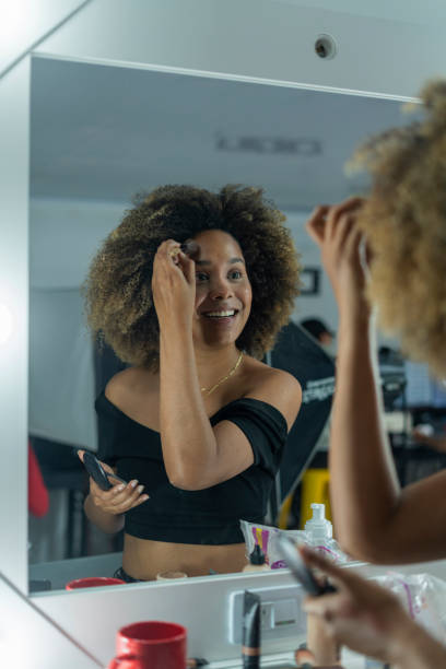 istock Professional makeup artist serves her client inside her beauty salon 2150739337