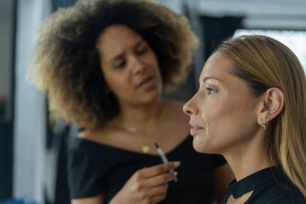 istock Professional makeup artist serves her client inside her beauty salon 2150739396