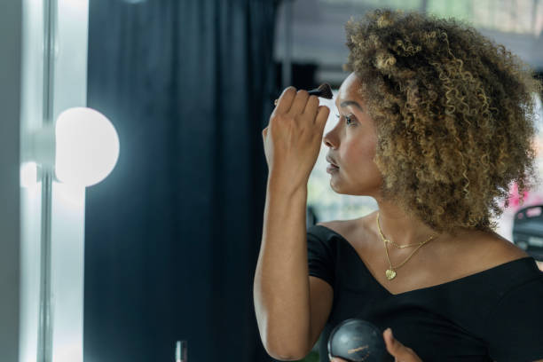 istock Professional makeup artist serves her client inside her beauty salon 2150739570