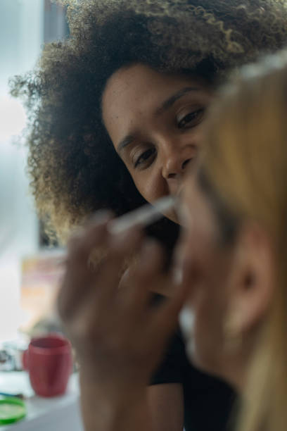 istock Professional makeup artist serves her client inside her beauty salon 2150740115