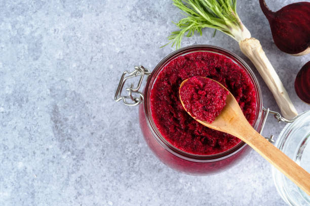 Beet horseradish sauce Creamy beet horseradish sauce in jar with a wooden spoon on top on a gray background. Appetizer or condiment for meat and fish. Healthy vegan food. top view kosher starter recipes stock pictures, royalty-free photos & images