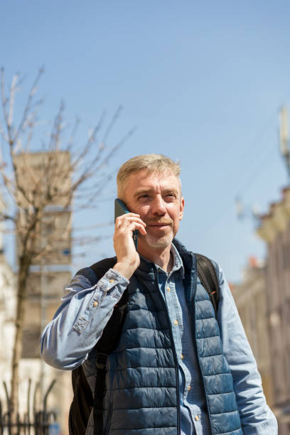 istock Cheerful 55 year old man talking on a mobile phone 2150740582