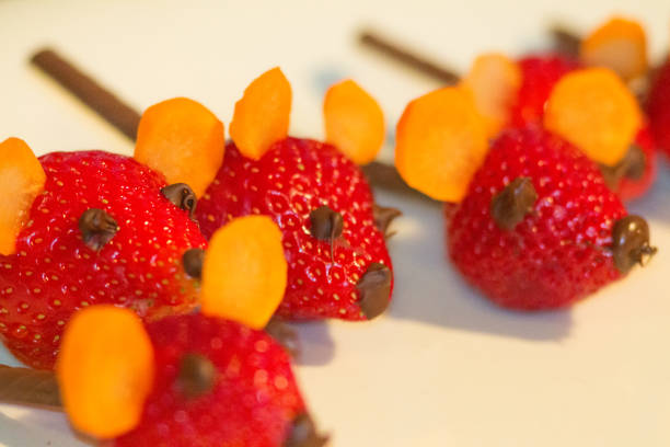 Scare the children in the class and the teacher and make chocolate carrot mice. Original fruit treat of strawberry, carrot and chocolate to stir things up.