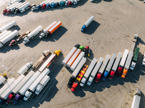 istock Vibrant Colored Semi Trucks and Trailers Parked at a Rest Stop in Springtime 2150742017