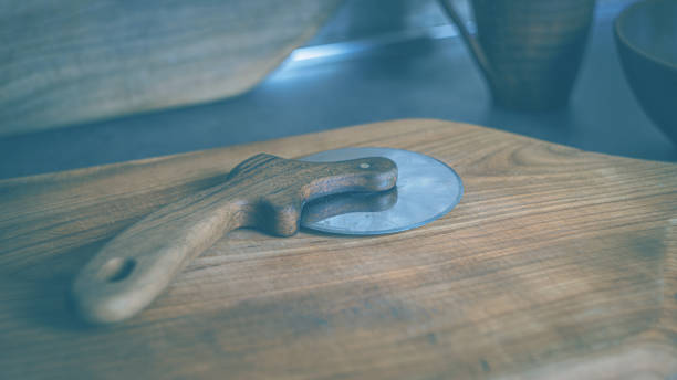 istock Pizza knife with wooden walnut handle on cutting board 2150742984