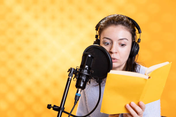 istock Narrator with shocked look on face recording horror audiobook, studio background 2150743830