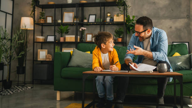 istock Father and son do homework together at home 2150744365