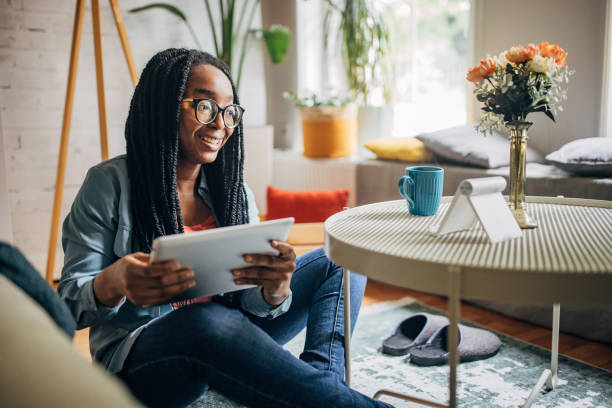 istock Casual woman browsing tablet on sofa at home 2150745340