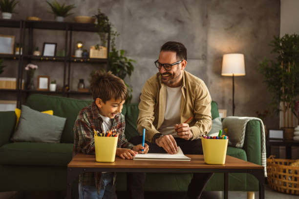 istock Father and son draw and paint together at home leisure activity 2150745455
