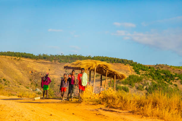 Fianarantsoa, Madagascar. 22 october 2023. Madagascar roads. daily life Malagasy. four young local guys are standing on the road looking for work