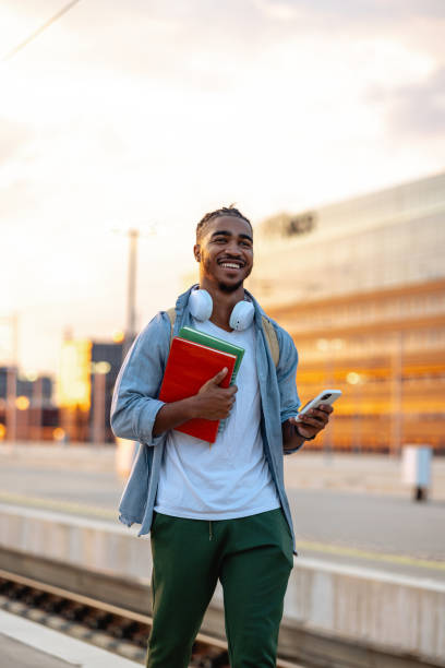 istock Cheerful Hispanic male student on the train station 2150746453