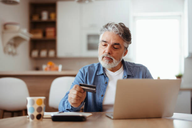 Man paying with credit card at home