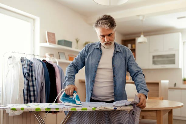 istock Man Ironing Shirt at Home 2150746674