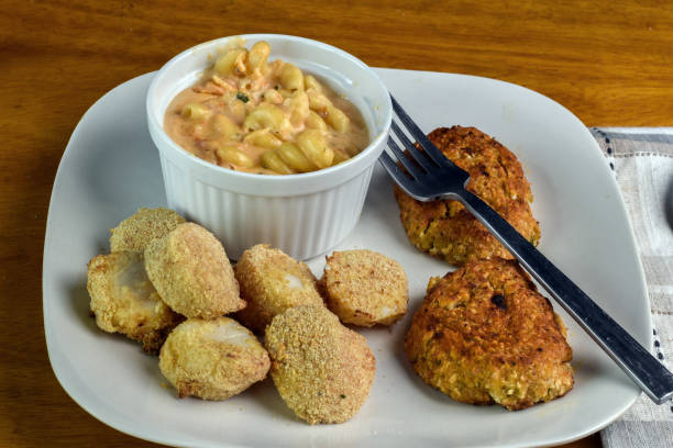 istock scallops with crab cakes and lobster mac and cheese 2150748871
