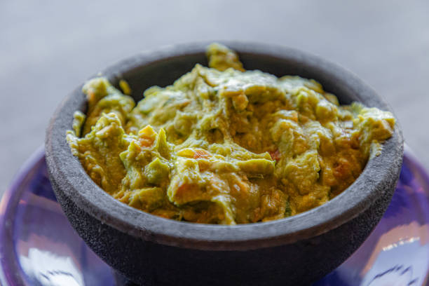 Close up of smashed avocado in a bowl