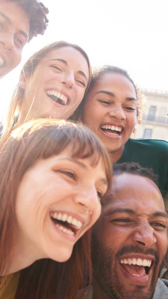 istock Happy smiling multiethnic group friends having fun together. Multiracial young colleagues embracing. 2150749261