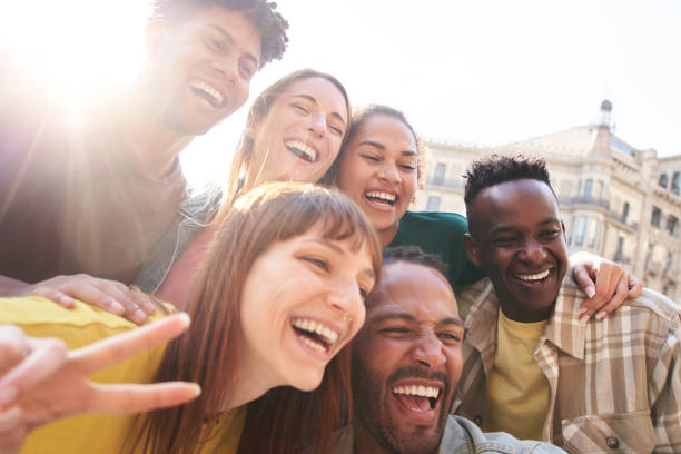 istock Happy smiling multiethnic group friends having fun together. Multiracial young colleagues embracing. 2150749813
